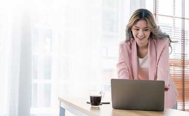 Portrait beautiful business asian creative pink suit woman online work office desk use computer copyspace Success business people employee freelance sme online marketing work at home, coworking space