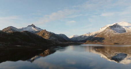 Fototapeta na wymiar Mirror of Nature: Lofoten Mountains Reflected in Calm Waters