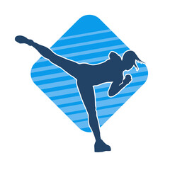 Silhouette of a female kickboxer athlete in action pose. Silhouette of a sporty woman doing kicking pose.