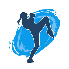 Silhouette of a female kickboxer athlete in action pose. Silhouette of a sporty woman doing kicking pose.