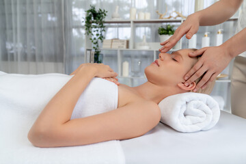 Caucasian woman enjoying relaxing anti-stress head massage and pampering facial beauty skin...