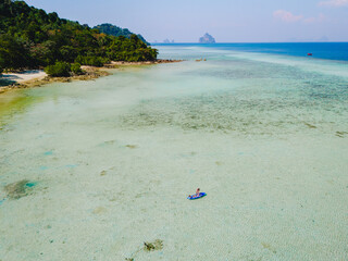 woman at peddle board sup at Koh Kradan a tropical island in Thailand