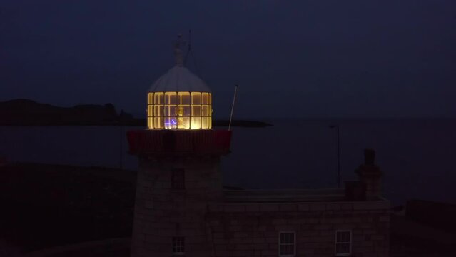 Aerial night shot featuring Howth harbour lighthouse and Ireland's eye