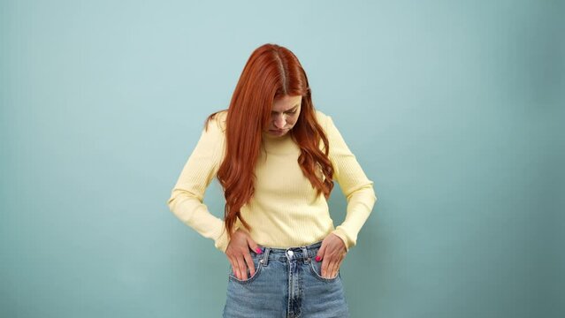 Woman looking for some money on her pockets but can't find anything and feeling broke