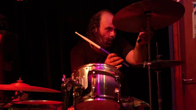 Drummer of a rock band during rehearsal in studio