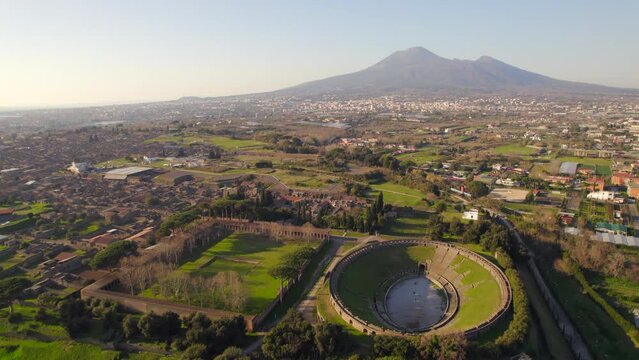 Ancient Roman amphitheater and archaeological city of pompeii at sunset. Aerial