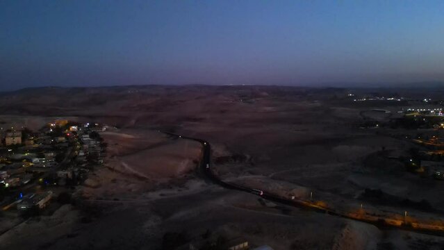 city in the desert at sunset, a main road leads to the city from the vastness of the desert.
Arad is a desert city in the Negev in southern Israel.
Drone shot