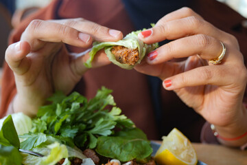 women eating Raw meatballs or cig kofte. Traditional Turkish cuisine delicacies.