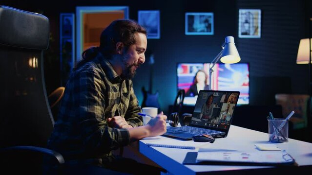 Remote worker talks with board of directors during videocall business meeting from home office. Teleworker speaks in remote videoconference telework call, receiving feedback from management, camera B