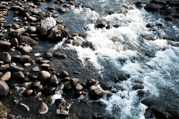 Water and stones meet in a natural landscape by the riverbank