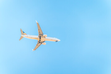 Airplane before landing in blue sky, Boeing 737-800