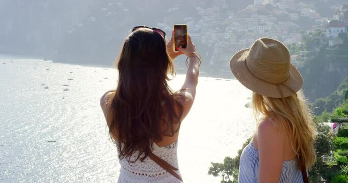 Phone, photography or friends in nature for travel, fun or adventure on summer, vacation or holiday. Smartphone, profile picture or back of women outside in Italy with memory, clip or scenic photo