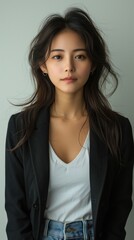 Obraz premium portrayal of a charismatic thailand student, capturing a model, with an engaging smile and sharp, calm long straight back hair, fitted blazer over a casual white tee paired with classic jeans, white b