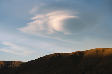 New Zealand landscape of clouds and mountains at sunset