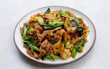 Stir-fried rice noodles with soy sauce and pork