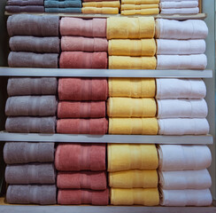 Fluffy towels were neatly folded and stacked on the shelves.