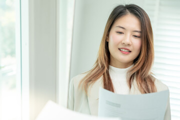 Beautiful woman preparing before job interview, building confidence, job applicants resume to...