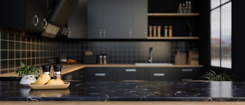 A space for displaying your product on a black marble kitchen countertop in a modern black kitchen.