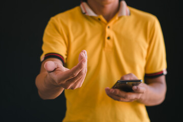 Fototapeta premium Close up footage shows a man using his phone, spreading his hands out.