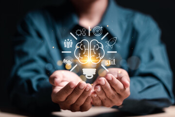 Start up new business idea with creative goal. Businessman holding virtual light bulb brain icon...