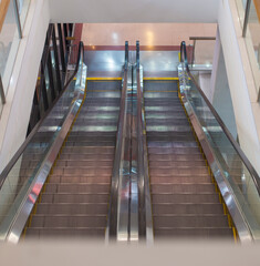 escalator a moving staircase consisting of an endlessly circulating belt of steps driven by a motor, conveying people between the floors of a public building.