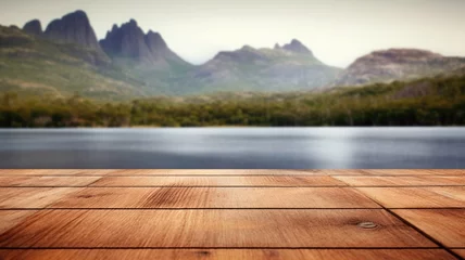 Wall murals Cradle Mountain The empty wooden brown table top with blur background of Cradle mountain in Tasmania. Exuberant image. generative AI