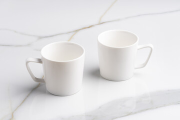 Ceramic cups on marble table against gray background