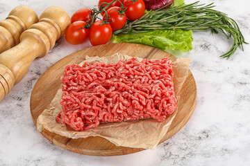 Raw minced beef meat on cutting board