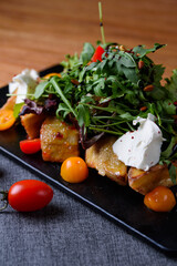 crispy eggplant with cheese and tomatoes, herbs
