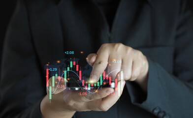 Finger pointing at market analysis with digital monitor.Businessman checking stock market data.Finance and stock exchange concept