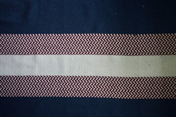 The texture of the woven fabric is striped in white, pink and blue for use in design.