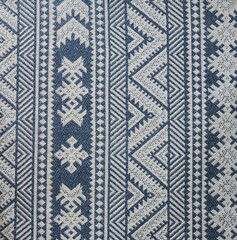 The texture of a woven fabric with a pattern of gray and blue colors for use in design.