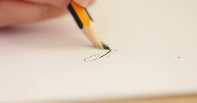 Person draws with pencil on paper and suddenly pencil breaks