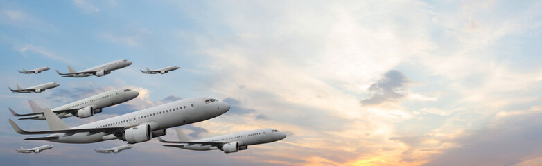 Planes flying on sunset sky with white cloud. Flight, fly and aircraft concept.