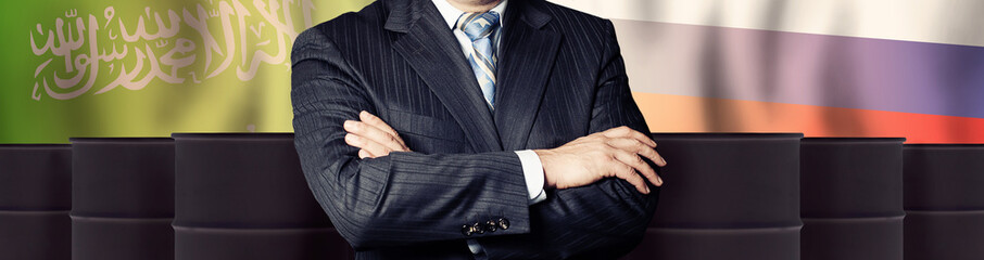 Politician or businessman on oil barrels background and background of Saudi Arabia and Russia flags