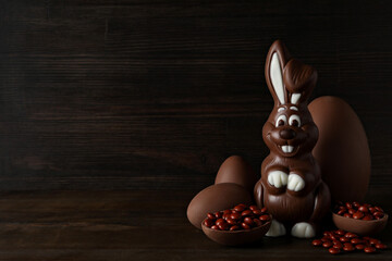 Chocolate eggs with a chocolate rabbit on a dark background