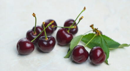 Red cherries and fruits on white mar