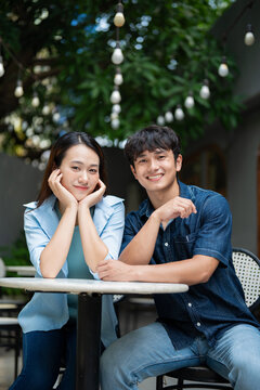 Photo of young Asian couple hang out together