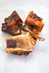 dried Beef knuckle dog bone chews and treats on mottled grey surface with copy space.