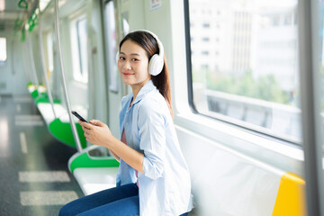 Photo of young Asian woman on metro