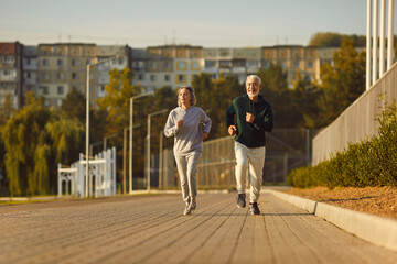 Senior couple on jogging sports workout that prevents cardiovascular disease and gives vitality...