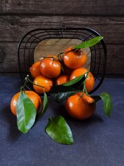 tangerines in a basket on dark background