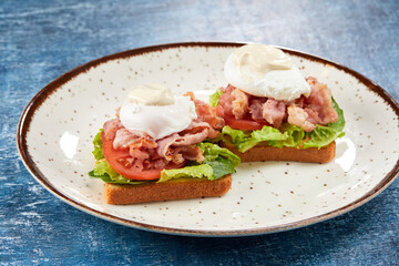 toasts with poached egg and bacon