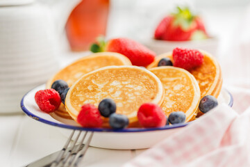 Homemade classic american pancakes with blueberries, raspberries and strawberries.