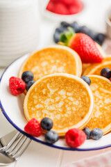 Homemade classic american pancakes with blueberries, raspberries and strawberries.