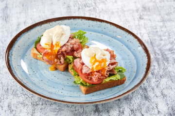toasts with poached egg and bacon