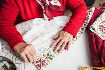 seamstress hands selecting fabric to cut