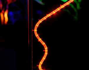 an orange curved led tube at night