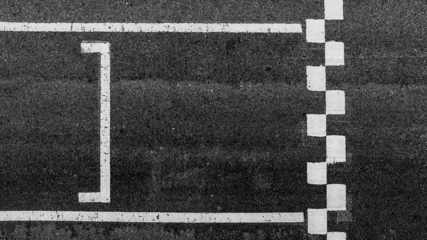 Stof per meter Aerial view abstract asphalt black Start and Finish grid line for race car in circuit texture background, Automobile and automotive background. © Kalyakan