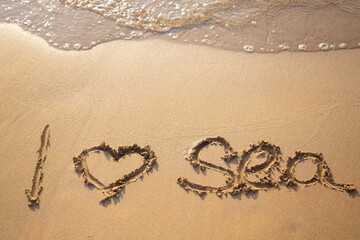 the inscription I love the sea made by hand in the sand on the sea coast. The concept of peace, relaxation, summer mood, vacation. travel with pleasure